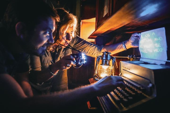 A man and woman looking at a clue