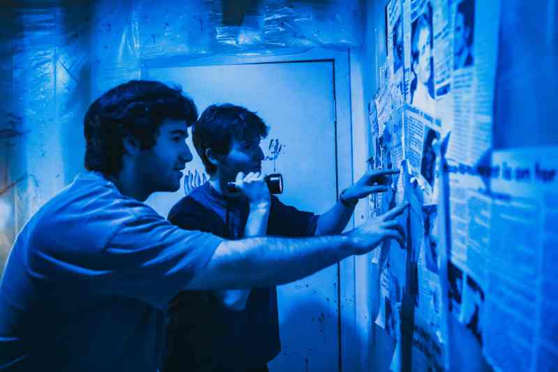 Two boys looking at newspaper articles