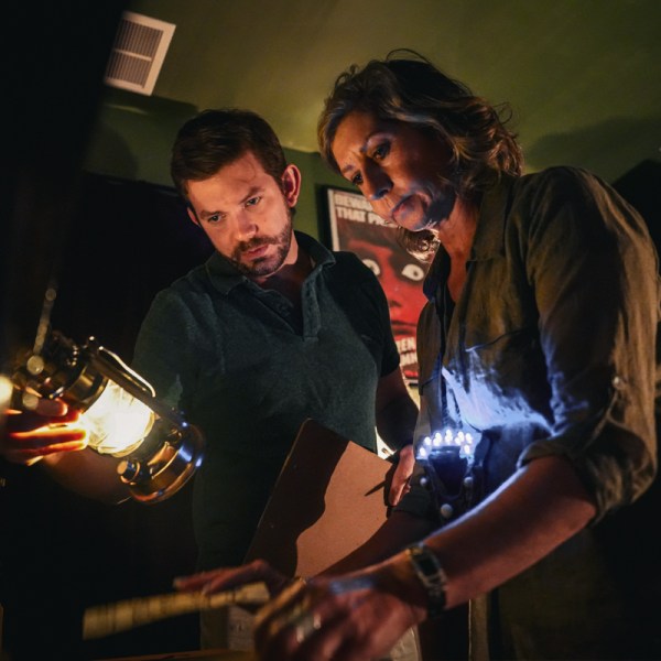 A man and woman looking using a lantern