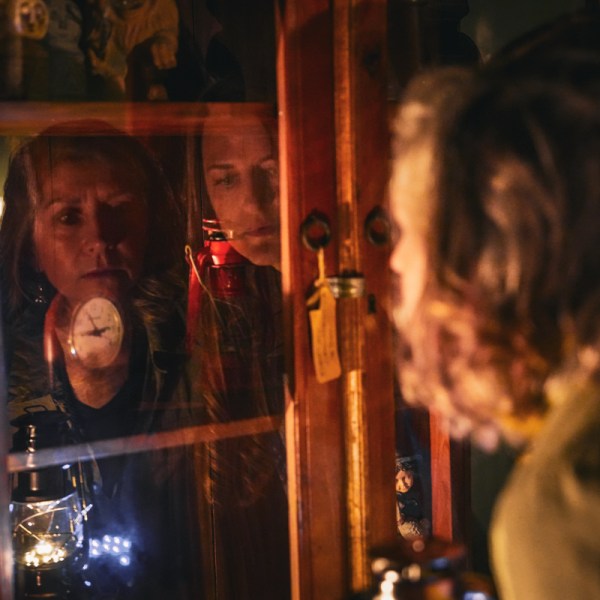 a group of people standing in front of a display cabinet