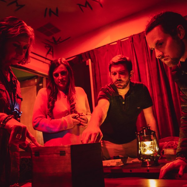 a group of people standing in a dark room