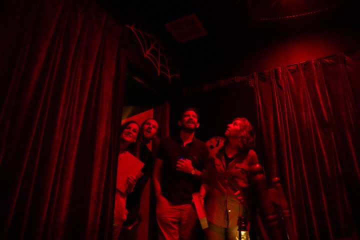 A group of people entering a red room